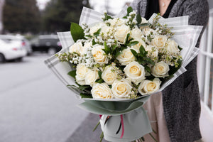 Hand tied White Roses Deluxe with waterproof wrapping by House of Fiori in Vancouver and Red Deer